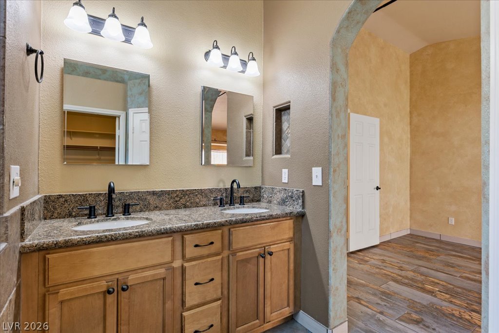 120 Ringlore Road Henderson, NV 89015 - Photo 23 of 58 Granite counters and double sinks anchor this well-appointed space framed by a stone-look archway.