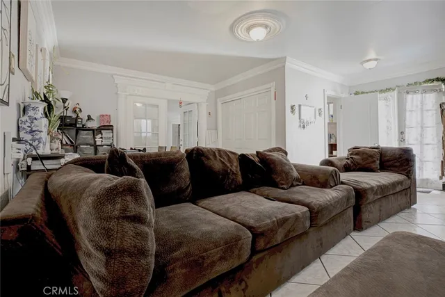 a living room with a couch and a mirror