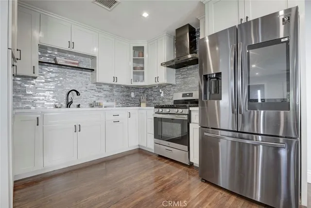 a kitchen with appliances a sink and a refrigerator