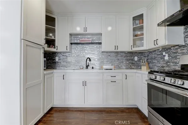 a kitchen with stainless steel appliances a stove and cabinets