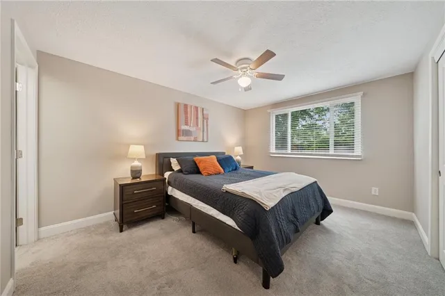 a bed room with a bed and a window