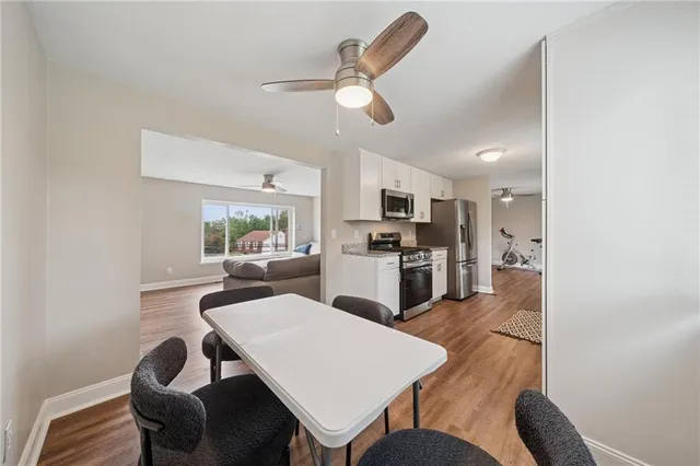 a living room with furniture and kitchen view
