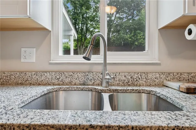 a kitchen with a sink and window