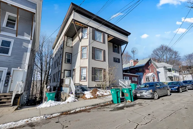 a view of a street that has couple of cars parked on the road