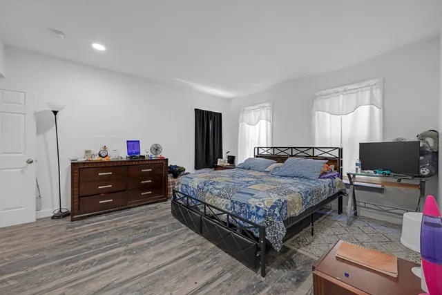 a bedroom with a bed and a dresser