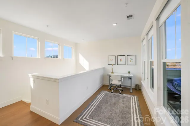 a spacious bedroom with a bed and a flat screen tv