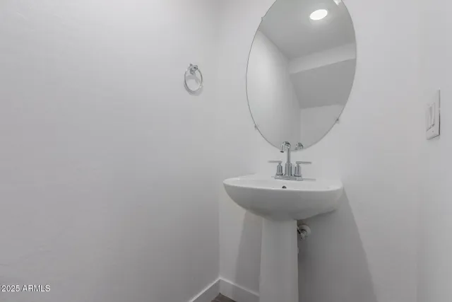 a bathroom with a sink a mirror and vanity