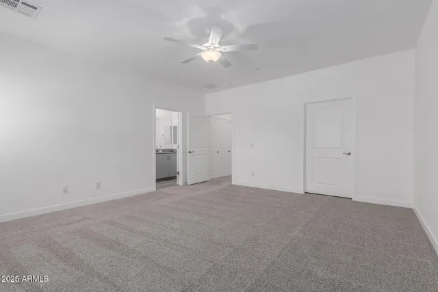 a view of an empty room with a ceiling fan