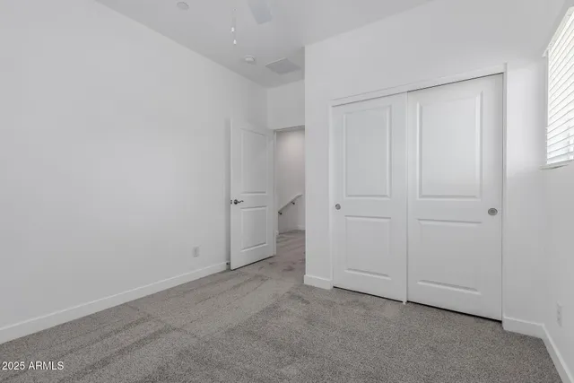 an empty room with closet area