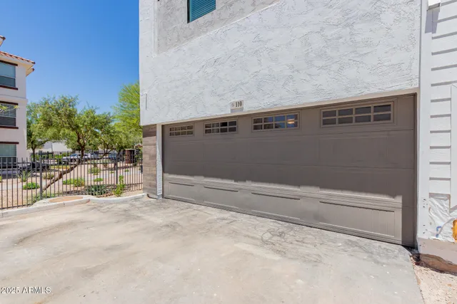 a view of backyard with a chair and potted plants