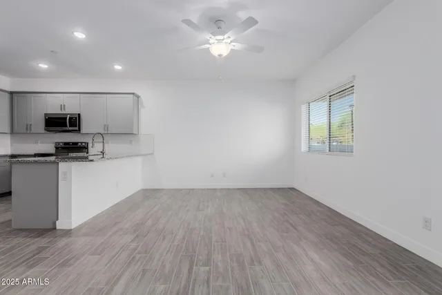 a view of kitchen with sink and wooden floor