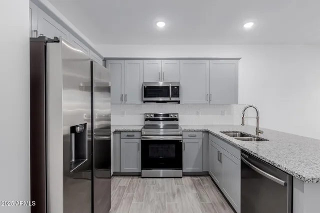 a kitchen with a sink stove and refrigerator