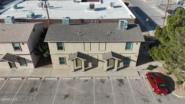 an aerial view of a house with large trees