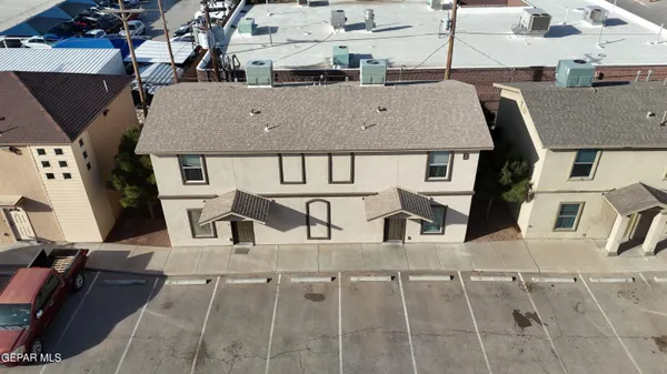 an aerial view of a house with streets and seating