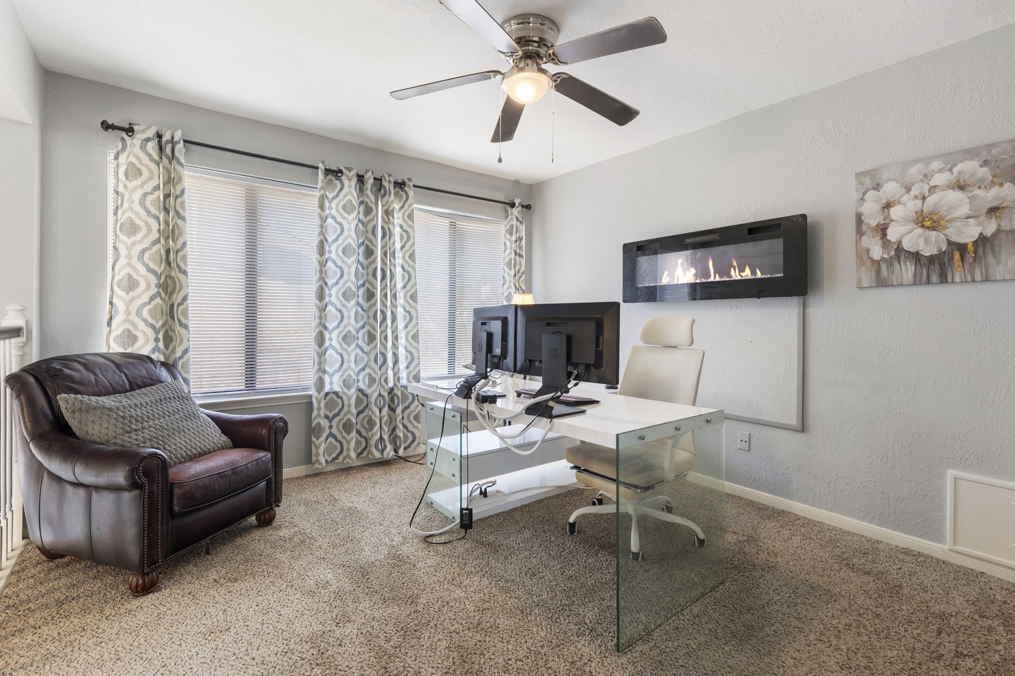 2110 Paso Rello Drive Houston, TX 77077 - Photo 24 of 41 This cozy home office features natural light that streams in through large windows with stylish curtains, creating a warm and inviting atmosphere.