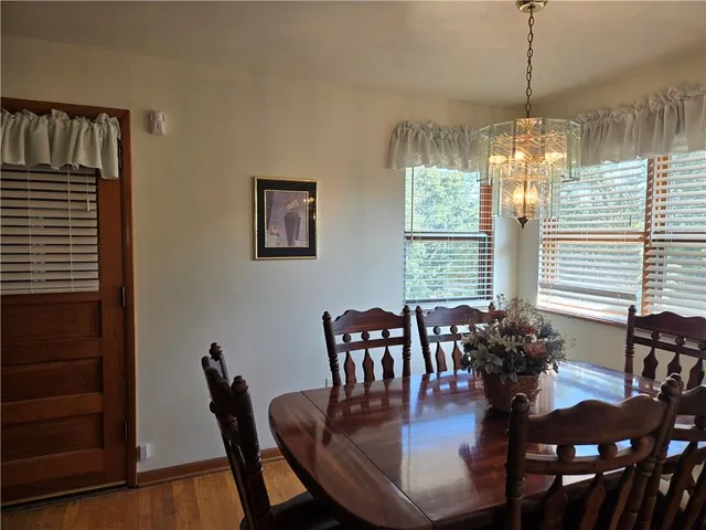 a dining room with furniture window and wooden floor