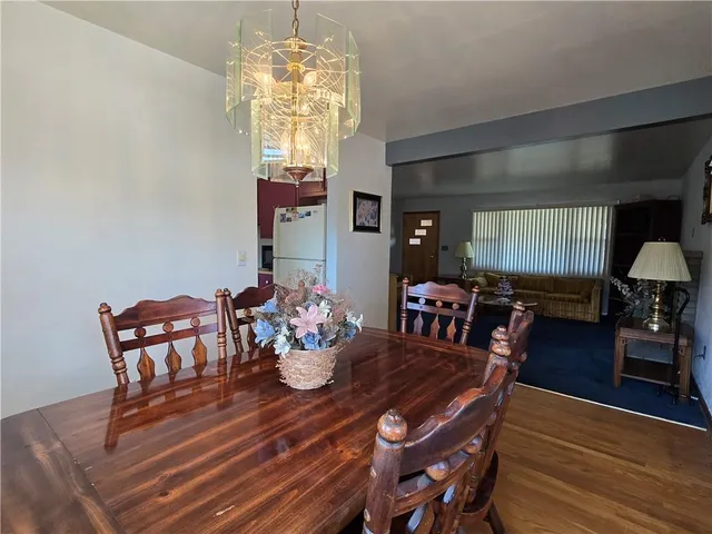 a view of a dining room with furniture and chandelier