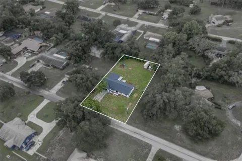 a front view of house with yard and trees in the background