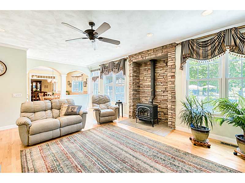 168 Kingston Road Exeter, RI 02822 - Photo 10 of 25 Living Room. Stonework surround gives a focal point for the wood burning stove. Windows overlook patio and pool.