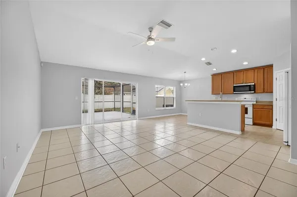 a kitchen with a refrigerator and a stove top oven