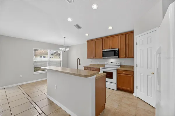 a kitchen with stainless steel appliances a sink stove and cabinets