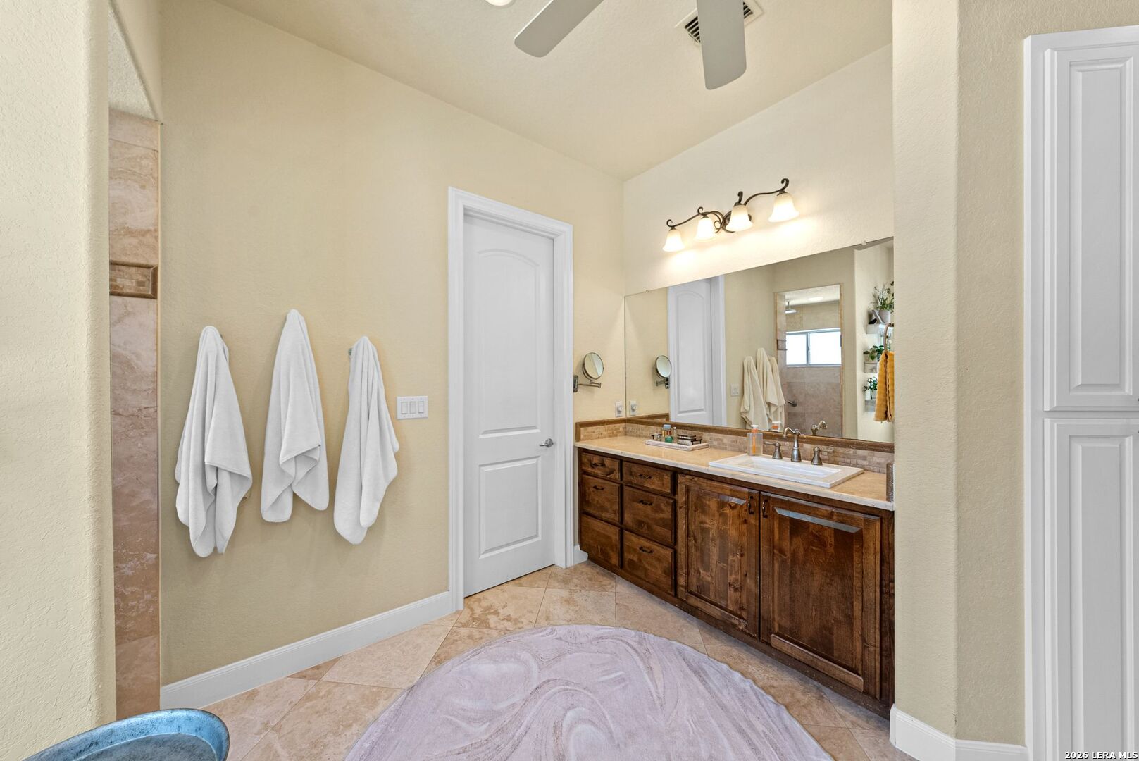 970 Flightline Spring Branch, TX 78070 - Photo 14 of 40 a spacious bathroom with a double vanity sink and a mirror