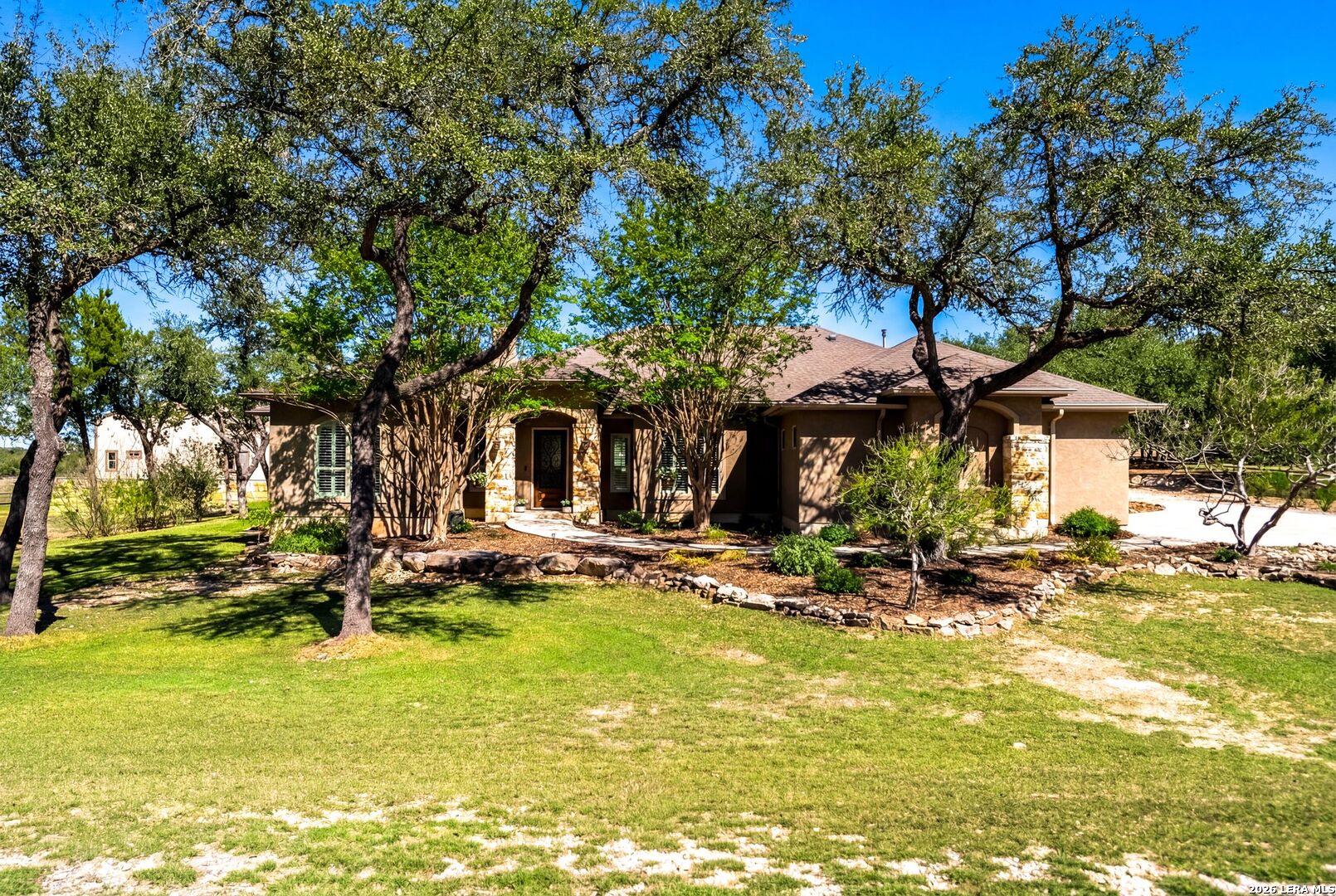 970 Flightline Spring Branch, TX 78070 - Photo 2 of 40 a view of a swimming pool with lawn chairs under an umbrella