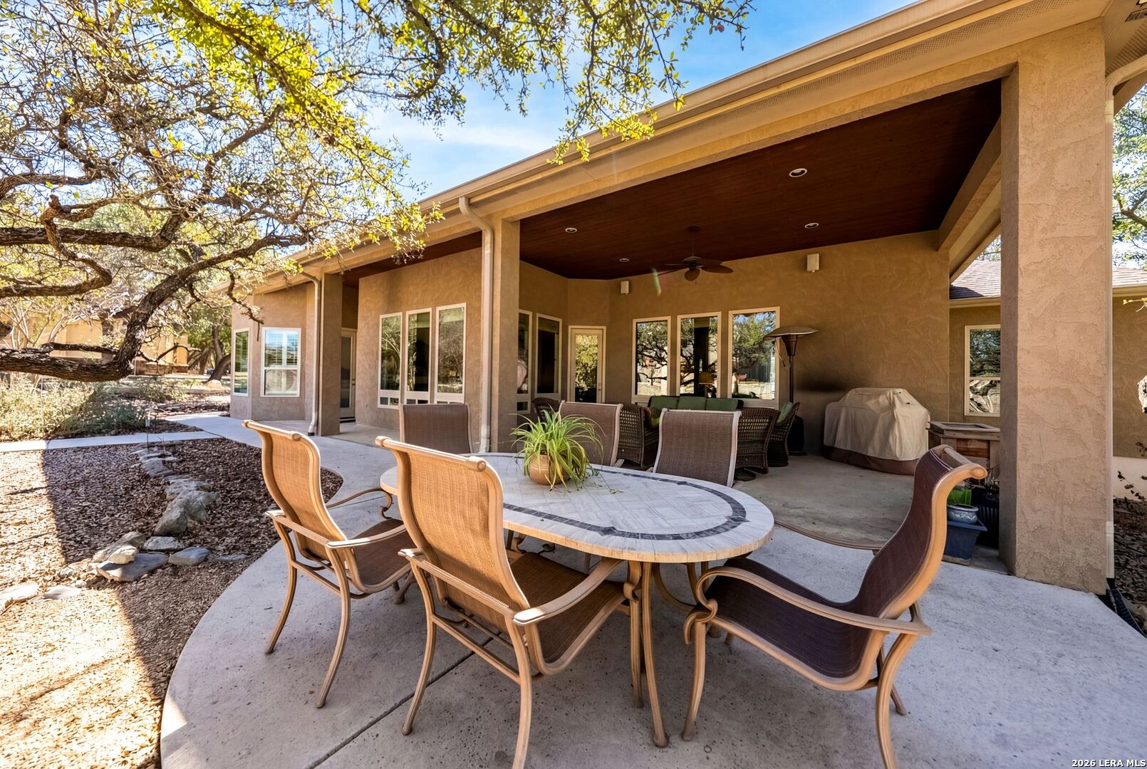 970 Flightline Spring Branch, TX 78070 - Photo 29 of 40 a view of a patio with a table and chairs and floor to ceiling window