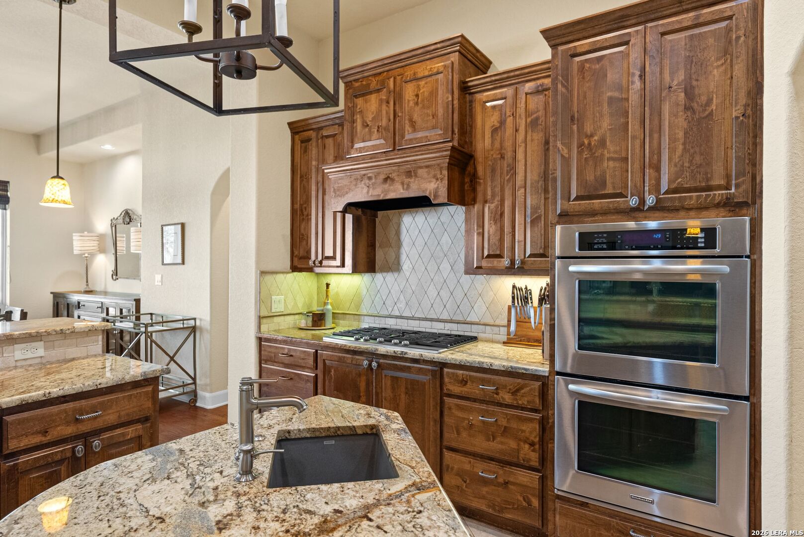 970 Flightline Spring Branch, TX 78070 - Photo 7 of 40 a kitchen with stainless steel appliances granite countertop a stove a sink and a refrigerator