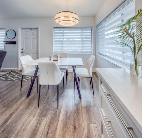 a view of a dining room with furniture window and wooden floor