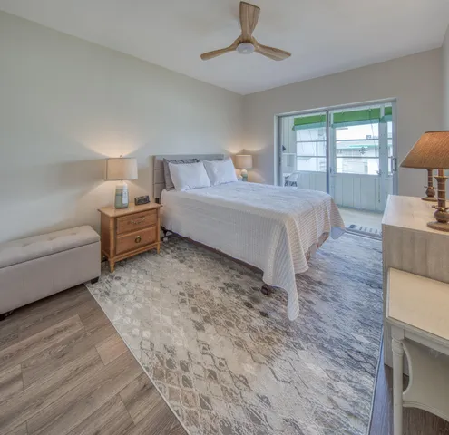 a spacious bedroom with a bed a couch and dresser