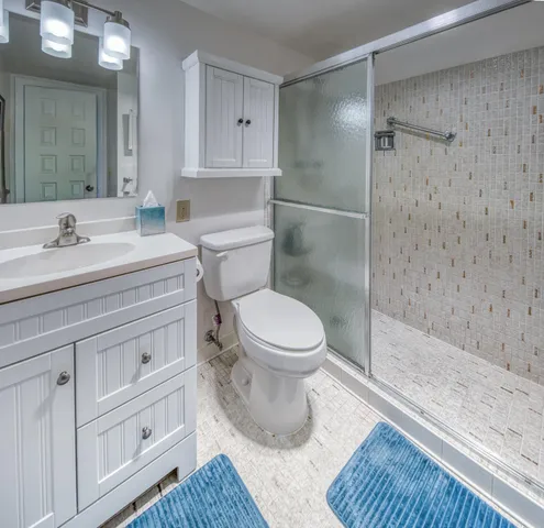 a bathroom with a sink toilet and shower