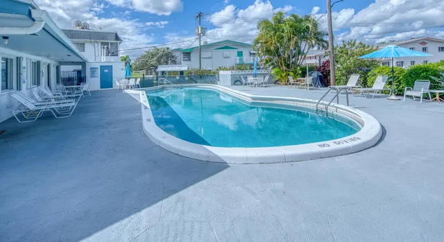 a view of a swimming pool with outdoor seating