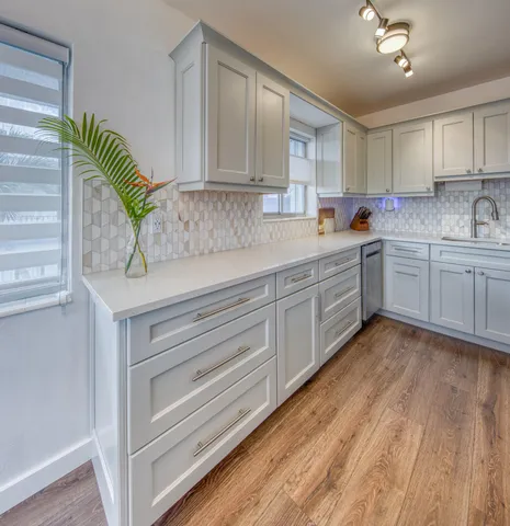 a kitchen with cabinets a sink and appliances