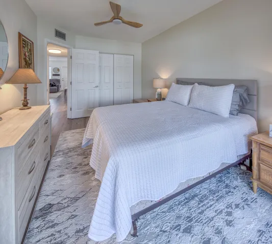 a bedroom with a bed and a lamp