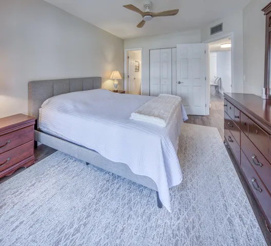 a spacious bedroom with a bed and a dresser