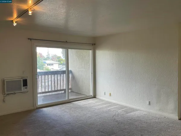 a view of a livingroom with an empty space and a fireplace