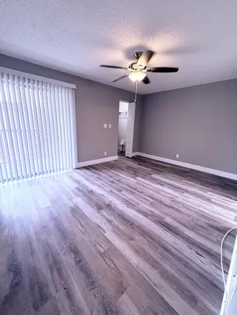 a room with gym equipment and a wooden floor