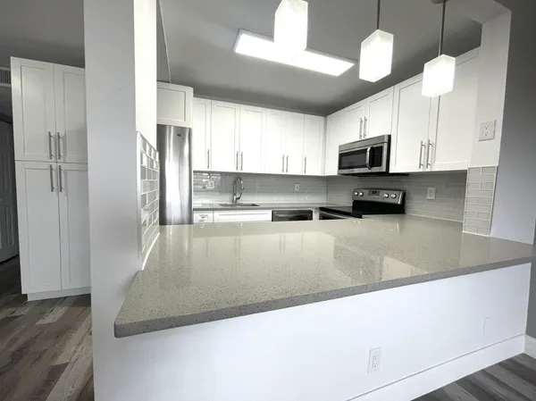 a view of kitchen and wooden floor