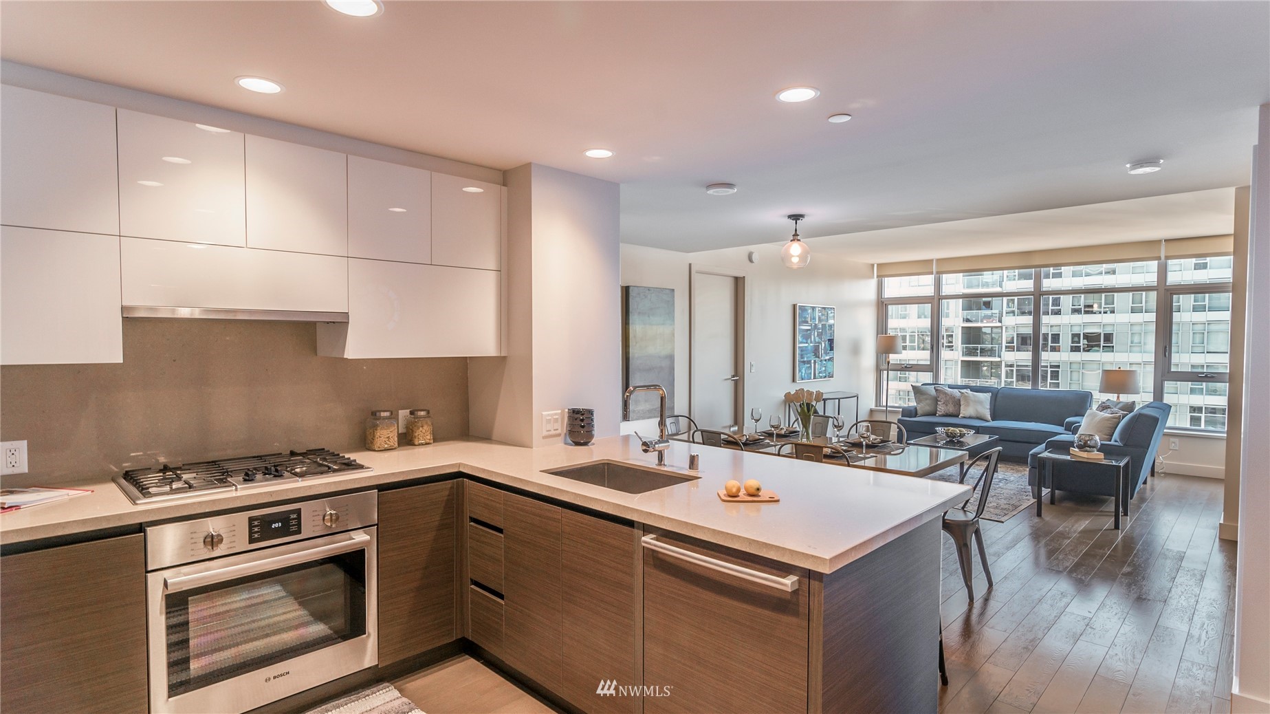 583 Battery Street, Unit 3207N Seattle, WA 98121 - Photo 8 of 22 a kitchen that has a sink a stove and a wooden floor