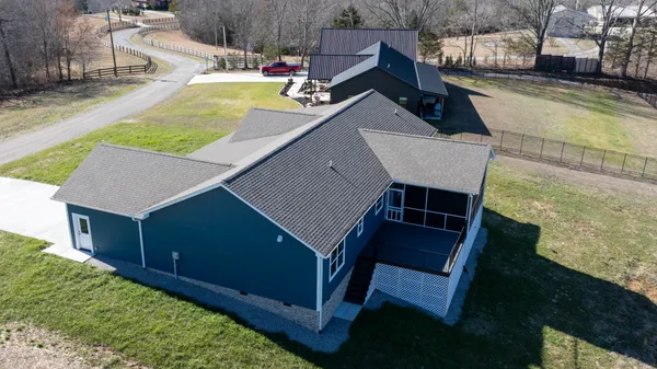 an aerial view of a house with a yard