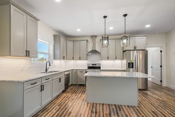 a kitchen with granite countertop a sink and cabinets