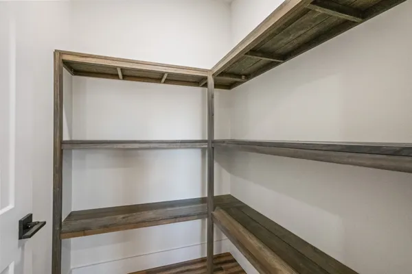 a spacious bedroom with a large bed and a chandelier