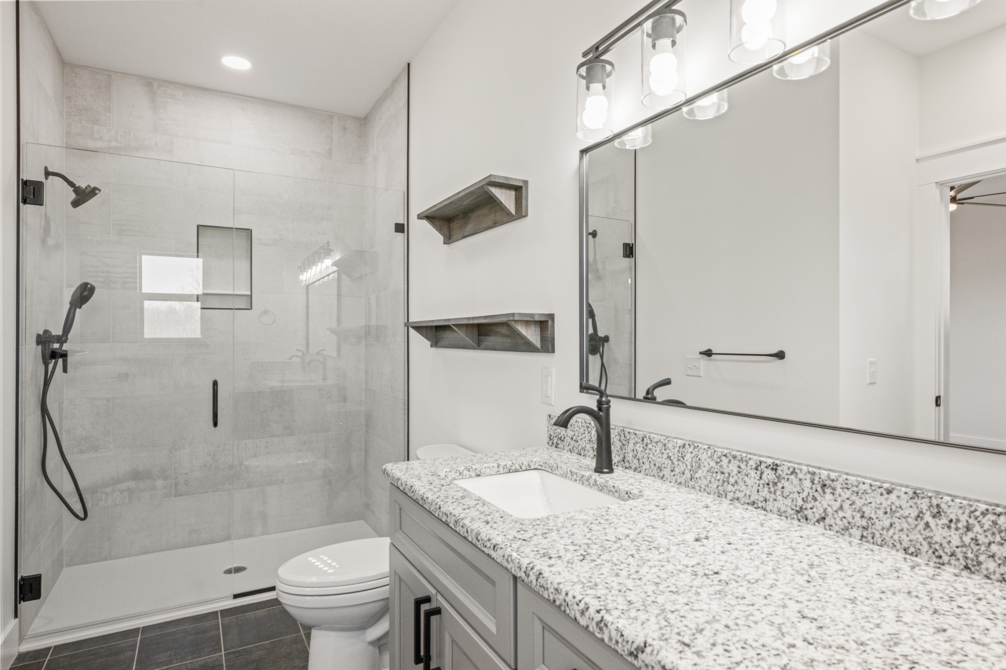 9345 Fox Hill Road Baxter, TN 38544 - Photo 35 of 54 a bathroom with a granite countertop sink a toilet and shower