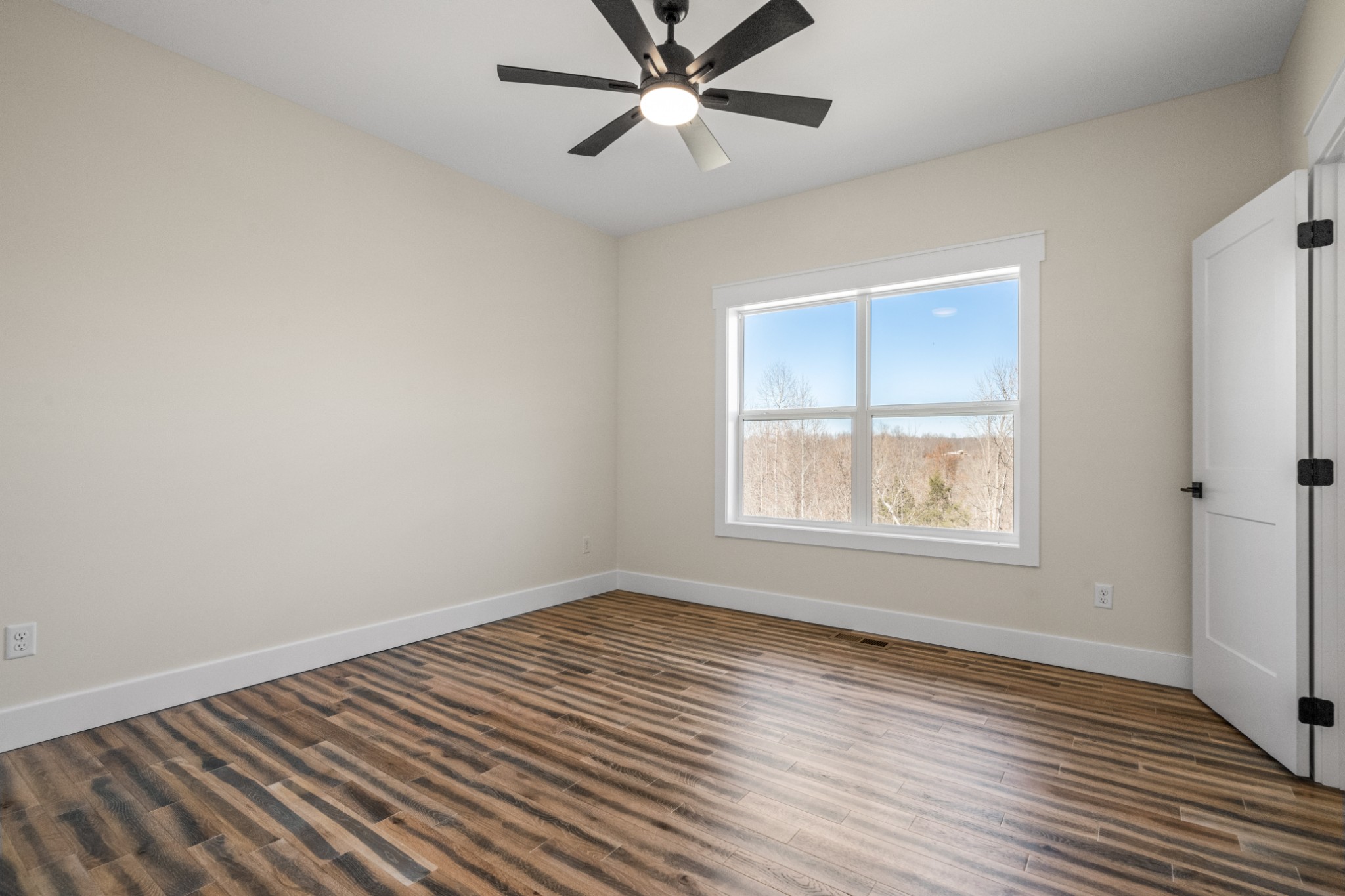 9345 Fox Hill Road Baxter, TN 38544 - Photo 40 of 54 a view of an empty room with wooden floor and a window