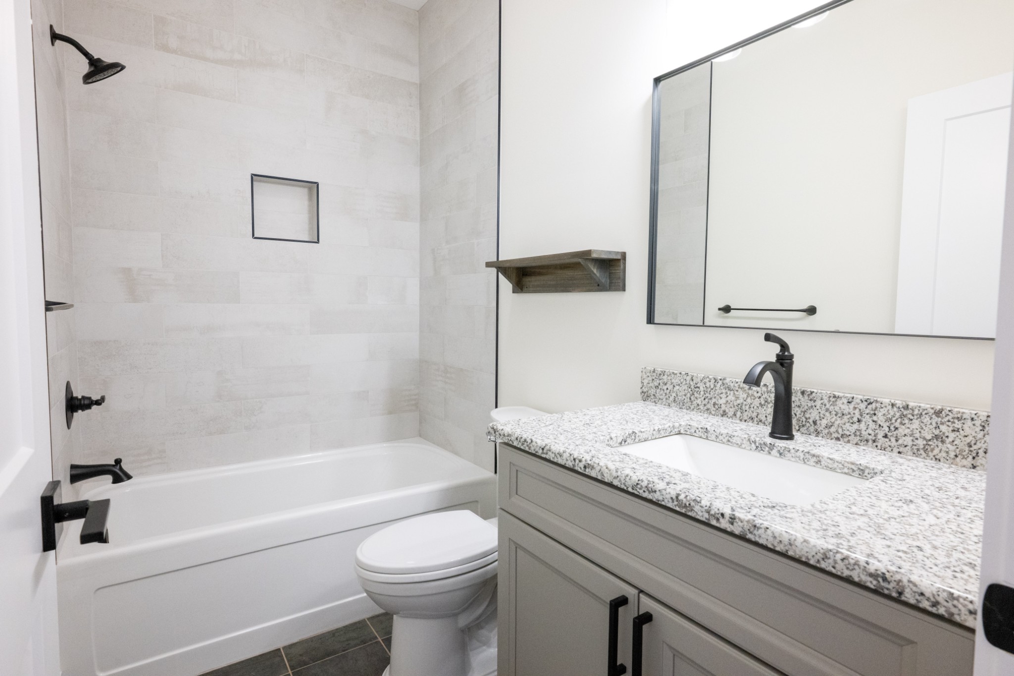 9345 Fox Hill Road Baxter, TN 38544 - Photo 43 of 54 a bathroom with a granite countertop sink a toilet and bathtub