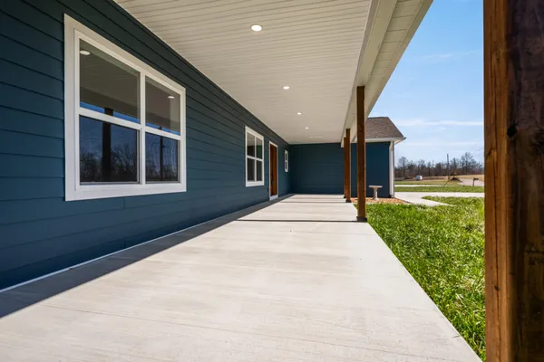 a living room with furniture and floor to ceiling windows