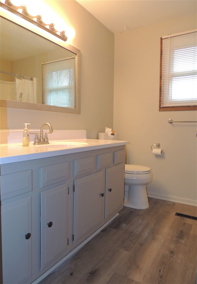11634 Crockett Road Roscoe, IL 61073 - Photo 13 of 26 a bathroom with a toilet sink and mirror