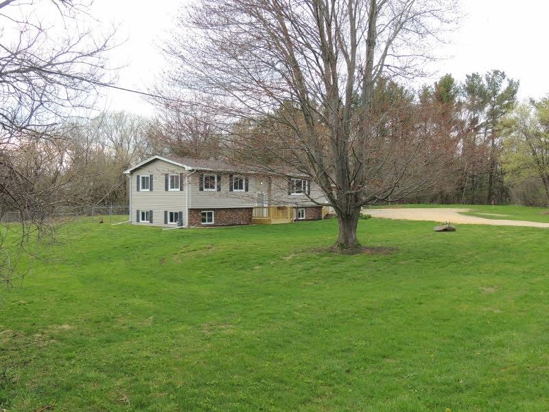11634 Crockett Road Roscoe, IL 61073 - Photo 3 of 26 a view of house with yard and tree in the background