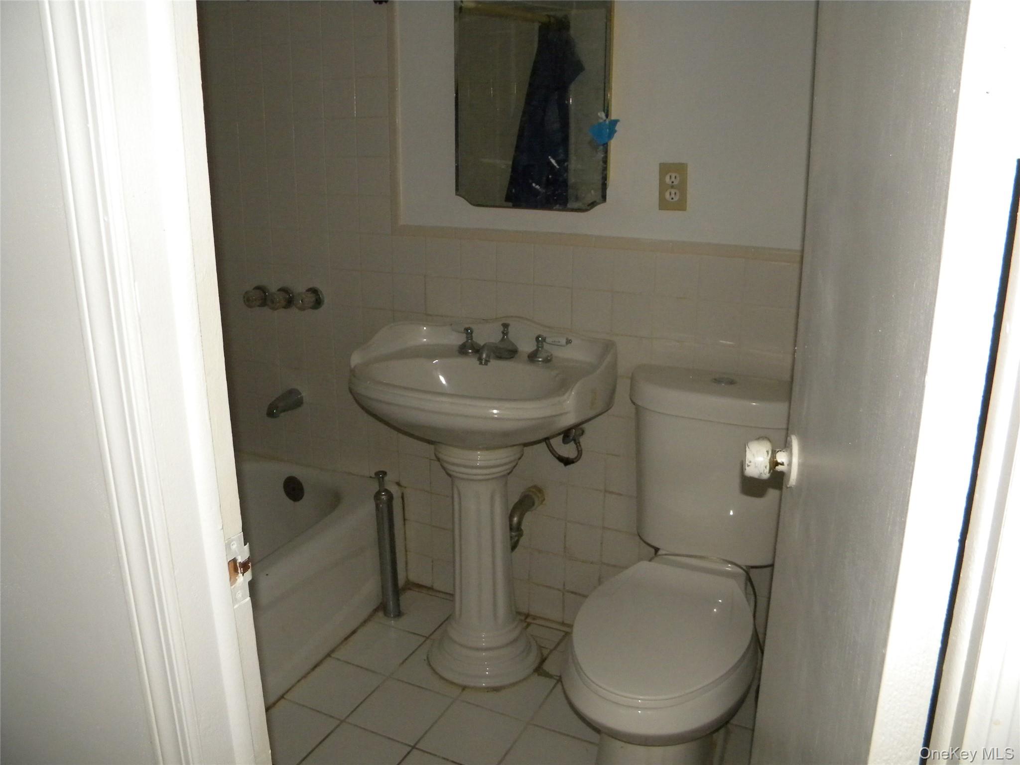 241-26 86th Road Queens, NY 11426 - Photo 28 of 38 a bathroom with a toilet sink and mirror